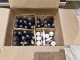 a cardboard box filled with bottles of beer on the floor