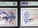 three different types of paper money are on display in a display case