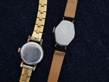 two watches sitting next to each other on a table