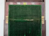 a wooden box with a green screen on the wall