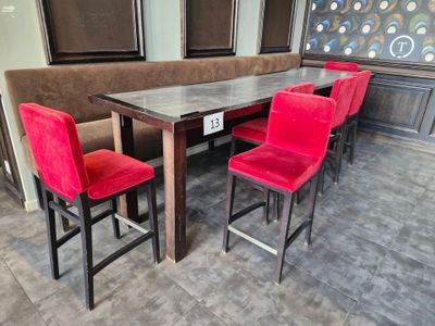 four red chairs sitting at a table in a restaurant
