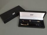 une boîte noire contenant un stylo doré