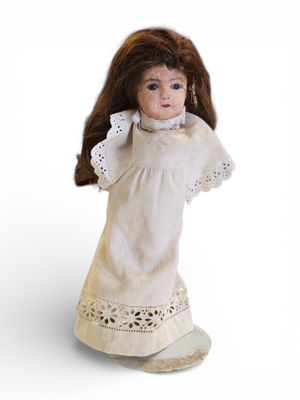 an image of a doll of a woman in a white dress