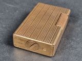 a gold lighter that is sitting on a table
