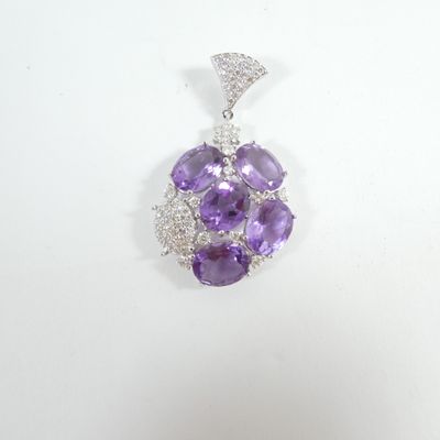 an amethorate and diamond pendant on a white background