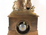 a bronze clock with a man and a woman on top of it