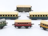 five toy trains that are sitting next to each other on a white surface