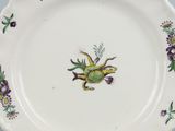 a plate with a frog on it on a table
