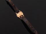 a close up of a watch on a black surface