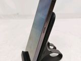 a cell phone that is sitting on top of a stand