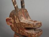 an image of a wooden sculpture of a goat ' s head with horns