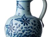 a blue and white vase with a bird on it