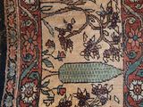 an image of a rug with a bird and flowers design on it