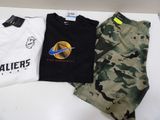 three t - shirts that are sitting on a table
