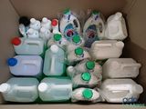 a cardboard box filled with plastic bottles and containers