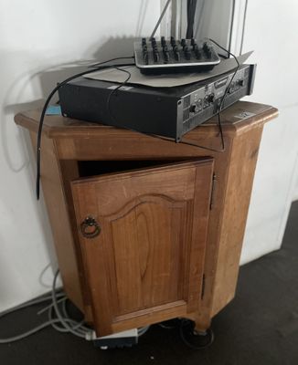 a wooden cabinet with a stereo system on top of it