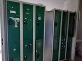 a row of green lockers in a public bathroom