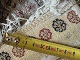 someone is measuring the length of a piece of fabric with a measuring tape