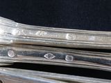 a close up of a pair of silver spoons on a table