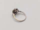 a close up of a ring with a diamond on it