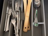 cutlers and utensils are in a divided tray on a counter