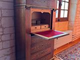 a wooden cabinet with a drawer on top of it