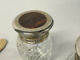 a glass salt and pepper shaker with a metal lid
