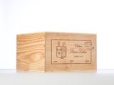 a wooden box with a label on it sitting on a table