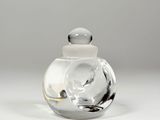 a clear glass jar with a white lid on a table