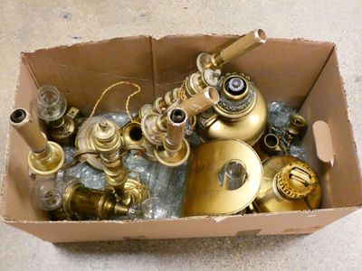 a cardboard box filled with assorted brass items
