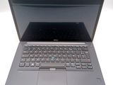 a laptop that is open on a white surface