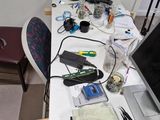 a desk with a laptop, a lamp, a cell phone, and other items on it