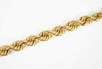 a close up of a gold chain on a white background