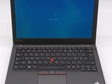 the laptop is open on a white surface with a blue screen