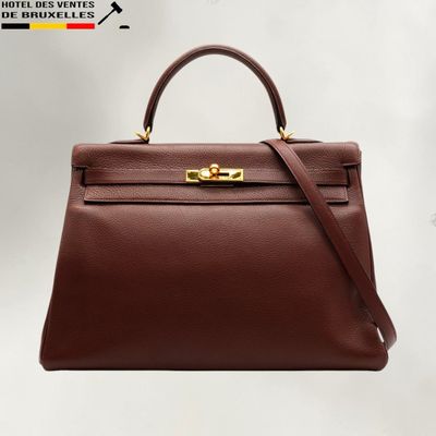 a brown leather handbag on a white background
