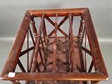 a wooden magazine rack with a magazine holder on it