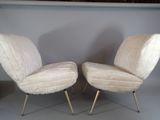 pair of mid - century modern lounge chairs with gold legs
