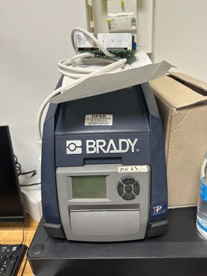a bottle of water sitting on a desk next to a printer