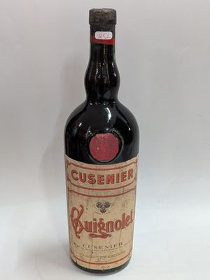 an old bottle of liquor sitting on top of a white surface