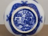 a blue and white plate with a picture on it