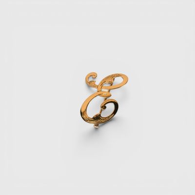 a close up of a gold ring on a white surface