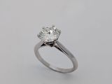 a close up of a diamond ring on a white surface