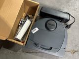 a box with a vacuum and a phone inside of it
