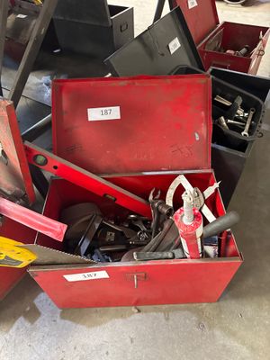 a red tool box with tools in it in a garage