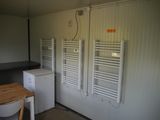a room with a table and a refrigerator in it