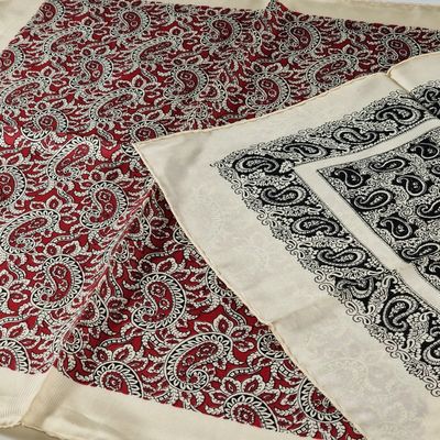 two pieces of cloth with a paisley design on them on a table
