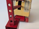 a red and yellow toy bus on a white surface
