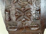 a close up of a wooden carving on a wall