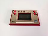 an image of a red and silver game console sitting on a white surface