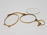 two pairs of glasses with a gold handle and a pair of glasses with a gold handle and a pair of glasses with a gold handle and a pair of glasses with